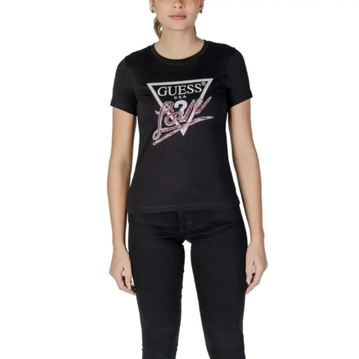 Black Guess Women’s T-shirt featuring a pink and white logo graphic design