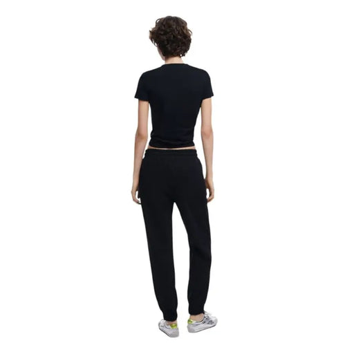 Black T-shirt and sweatpants outfit featuring Light Blue Denim Jogger Pants with Black Side Stripes