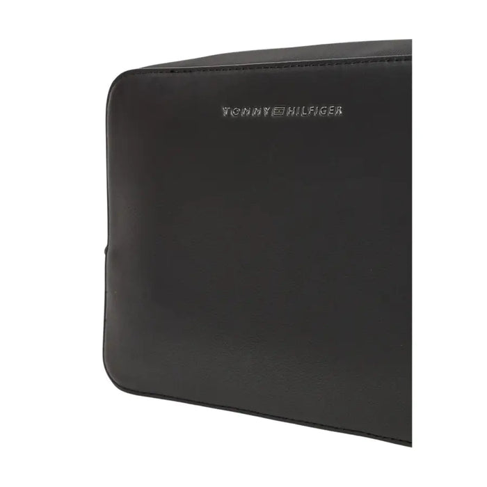 Black Tommy Hilfiger bag with zippered pouch and wristlet for stylish organization