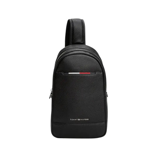 Black textured leather Tommy Hilfiger sling bag displayed for fashion and accessory use