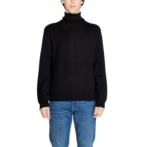 Black turtleneck sweater with ribbed detailing and long sleeves.