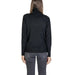 Black turtleneck sweater with side zippers paired with gray jeans for a stylish look