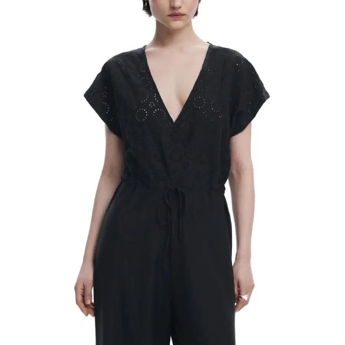 Black V-neck embellished wrap jumpsuit displayed on a model for elegant evening wear