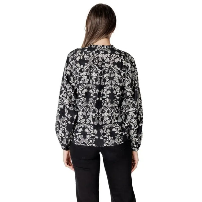 Black and white floral print blouse for women displayed in product listing