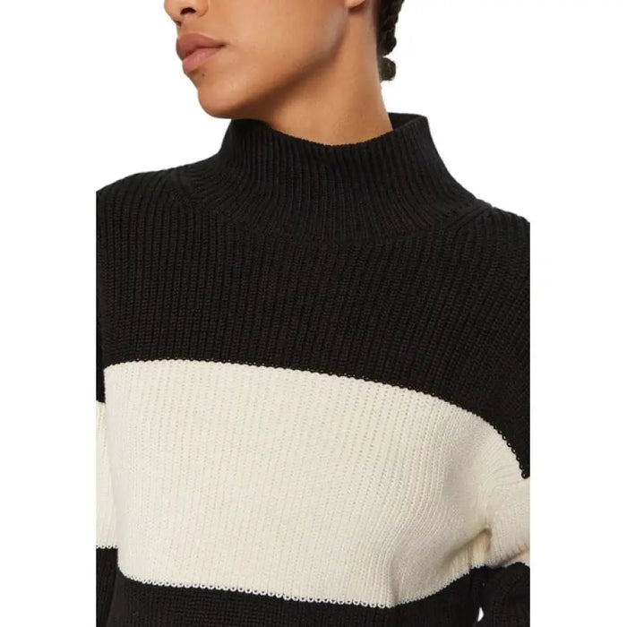 Black and white striped turtleneck sweater displayed in the product image