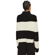 Black and white striped turtleneck sweater displayed in a product image