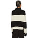 Black and white striped turtleneck sweater displayed in a product image