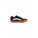 Black and white Vans sneaker with a brown sole displayed in the product image