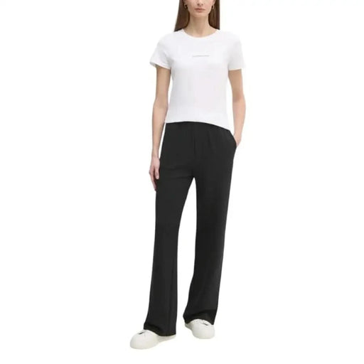 Black wide-leg sweatpants with white t-shirt and sneakers styled for Calvin Klein Jeans