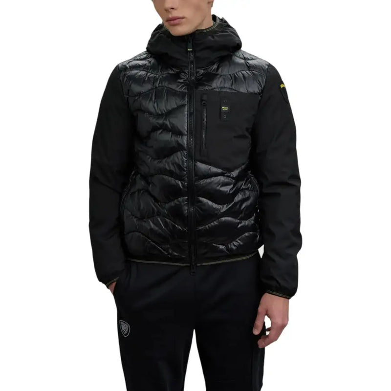 Black puffer jacket with hood and zipper, made of synthetic material.
