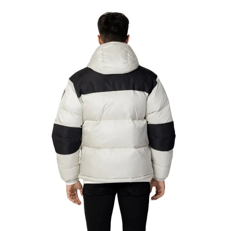 Blauer men’s grey winter jacket with a puffy white body and black shoulder panels, cuffs, and hood lining
