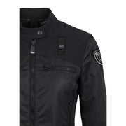 Black Bianca USA porte un blazer noir à col roulé zippé pour femme, avec poches avant et fermeture éclair.