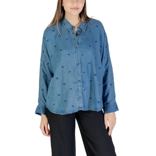 Blue button-down shirt featuring a heart pattern, ideal for stylish casual wear