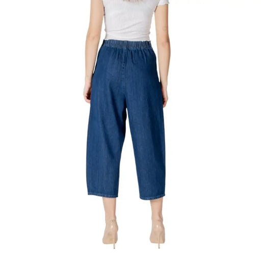 Blue denim culottes paired with beige heels in a stylish fashion display
