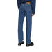 Blue denim jeans displayed with a denim jacket and black loafers for a stylish look