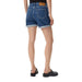 Woman wearing a black T shirt and blue denim shorts suitable for casual wear