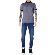 Gray and black polo shirt with contrast tipping, slim fit jeans, dark blue sneakers.