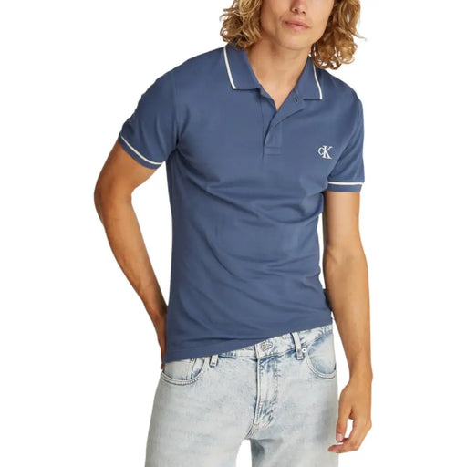 Men’s blue polo shirt with white trim paired with lightwash jeans for a classic look