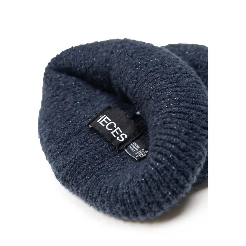 Dark blue polyester women’s cap with subtle glittery texture and black ieces brand tag for fall and winter use