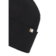 Black beanie with gold label and ribbed texture.