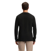 Black long-sleeved crew neck sweater with ribbed cuffs and hem, likely made of cotton or a similar soft fabric.