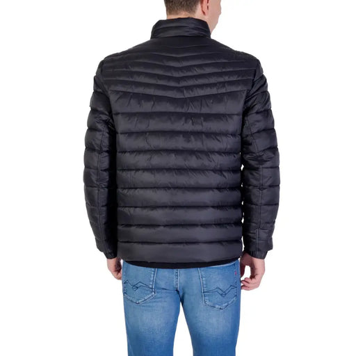 Black quilted puffer jacket with star pattern, likely made of synthetic material.