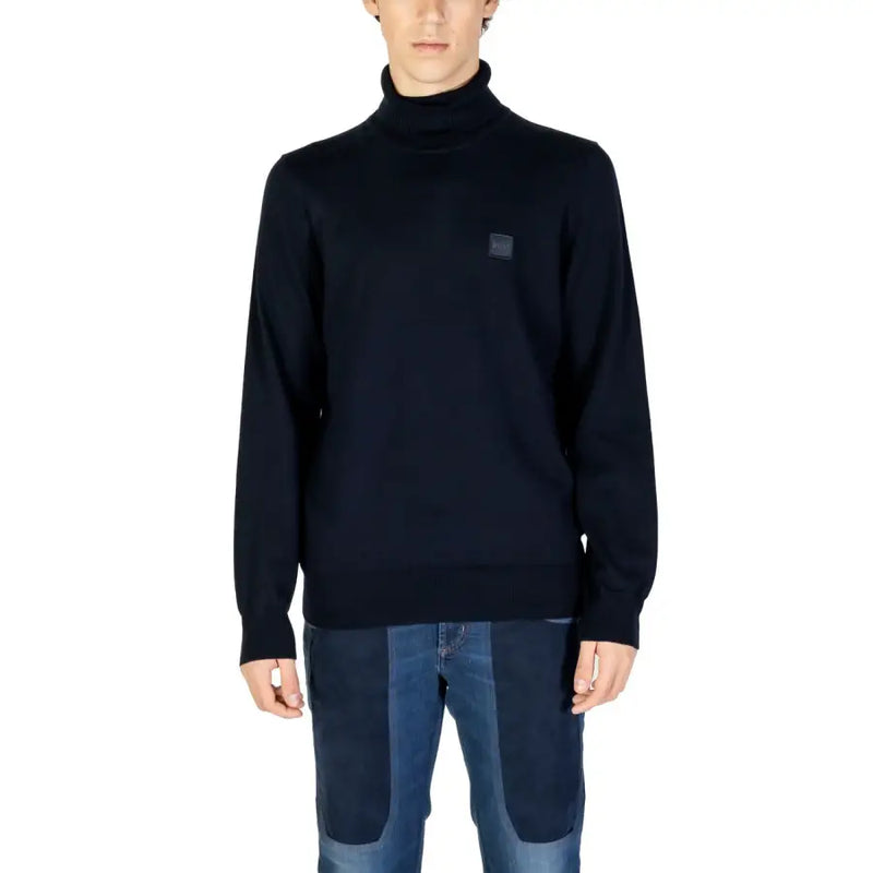 Navy blue turtleneck sweater with a small logo on the chest.