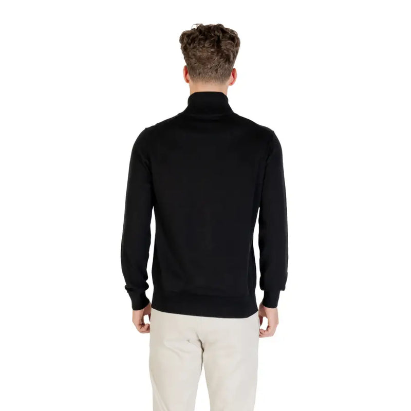 Black zip-up sweater with ribbed cuffs and hem, likely made of cotton or polyester blend.