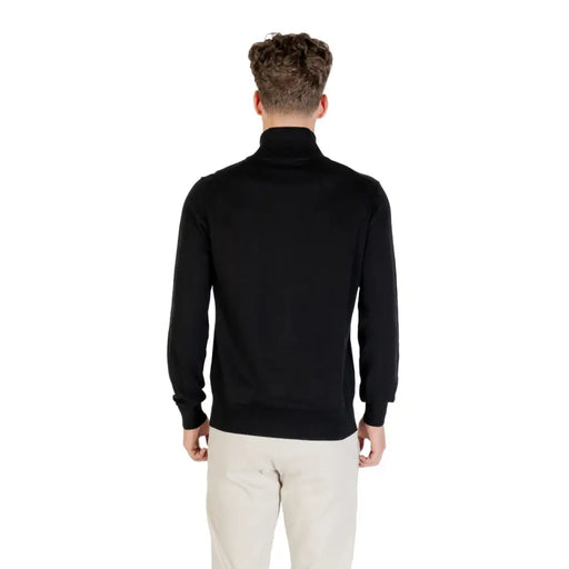 Black zip-up sweater with ribbed cuffs and hem, likely made of cotton or polyester blend.
