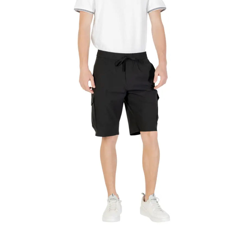 Black cargo shorts with drawstring waist and multiple pockets, likely made of cotton or polyester blend.