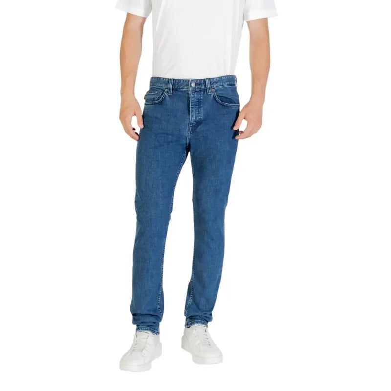 Blue denim jeans with a slim fit and white stitching, likely from levi’s 512 model.