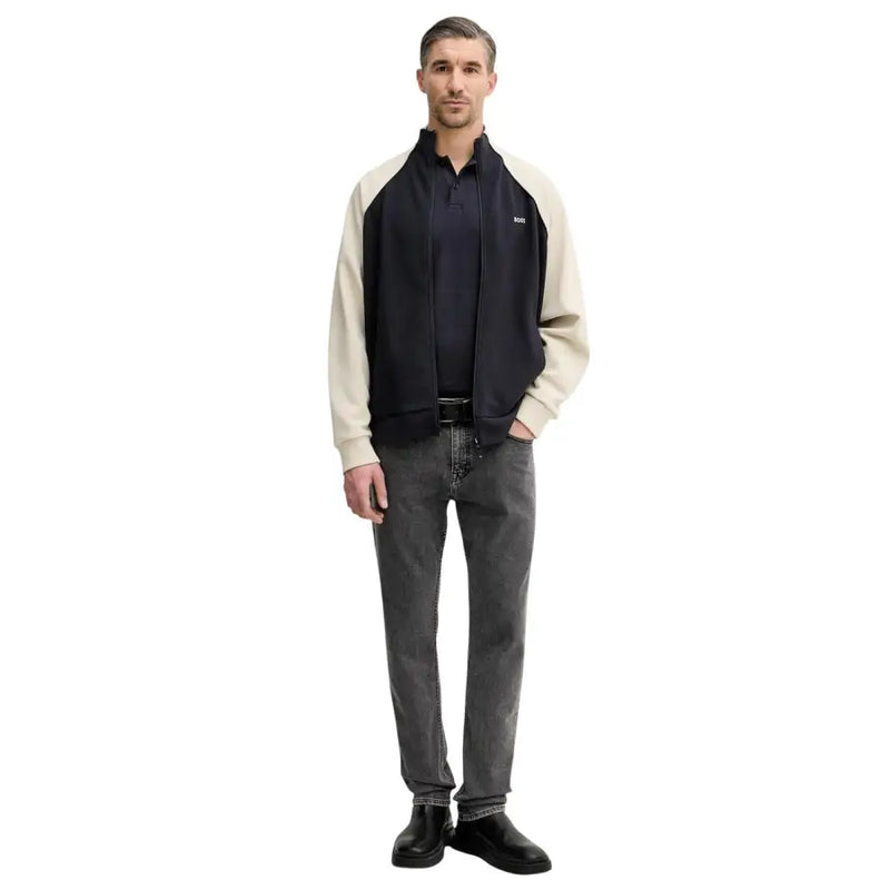 Blouson bomber bicolore bleu marine et crème en coton stretch, fermeture éclair sur le devant et logo discret de la marque sur la poitrine