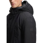 Manteau d'hiver long à capuche pour homme Black Boss, doublure matelassée en polyester et écusson discret sur la manche.
