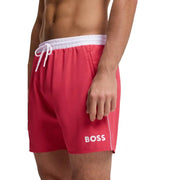 Bright red Boss men swim trunks with white elastic waistband and drawstring featuring bold white logo on lower left leg
