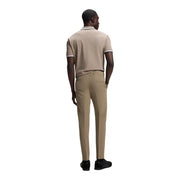 Beige short-sleeved polo shirt with white trim on collar and cuffs complementing boss men trousers collection
