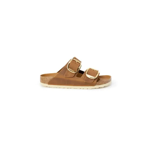 Brown leather Birkenstock women’s sandals featuring gold buckles for stylish comfort