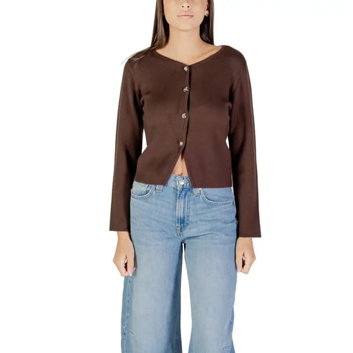 Brown long-sleeved V-neck button-up cardigan paired with light blue wide-leg jeans for women