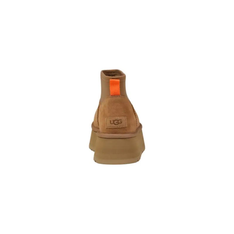 Brown platform ugg boot showing back side made of tan suede with chunky sole and orange pull tab