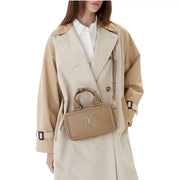Beige leather Calvin Klein zippered womens handbag with prominent CK logo measuring 22 by 12.5 by 7 centimeters