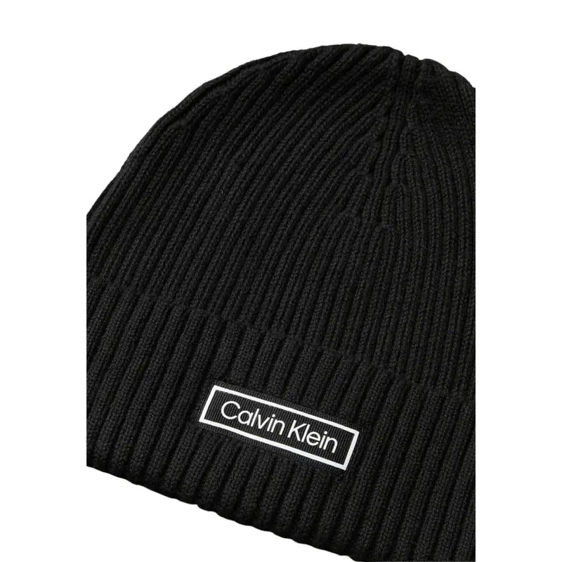 Black ribbed calvin klein beanie with white logo.