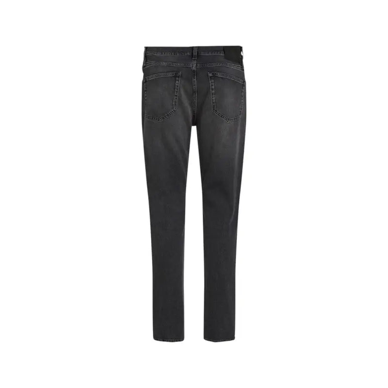 Black leather pants with distressed details and a slim fit.