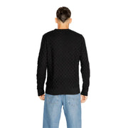 Black cable-knit sweater with a textured pattern and ribbed cuffs, collar, and hem.