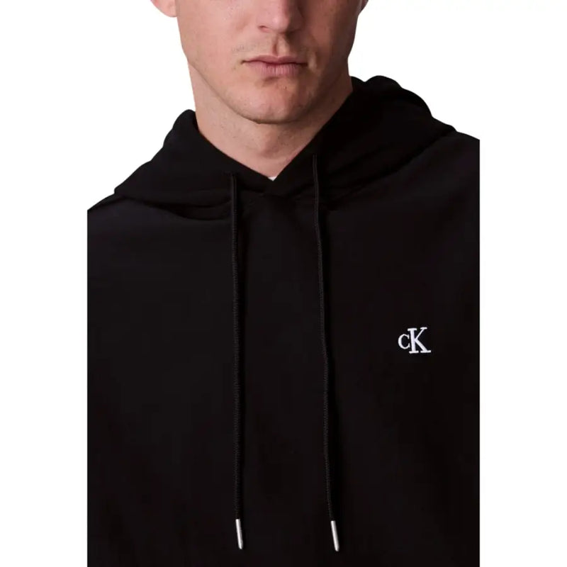 Calvin Klein black hoodie with subtle white embroidered logo on chest and matching drawstrings in cotton material