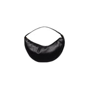 Calvin Klein black polyurethane crescent-shaped shoulder bag with zip closure and interior pockets in minimalist design