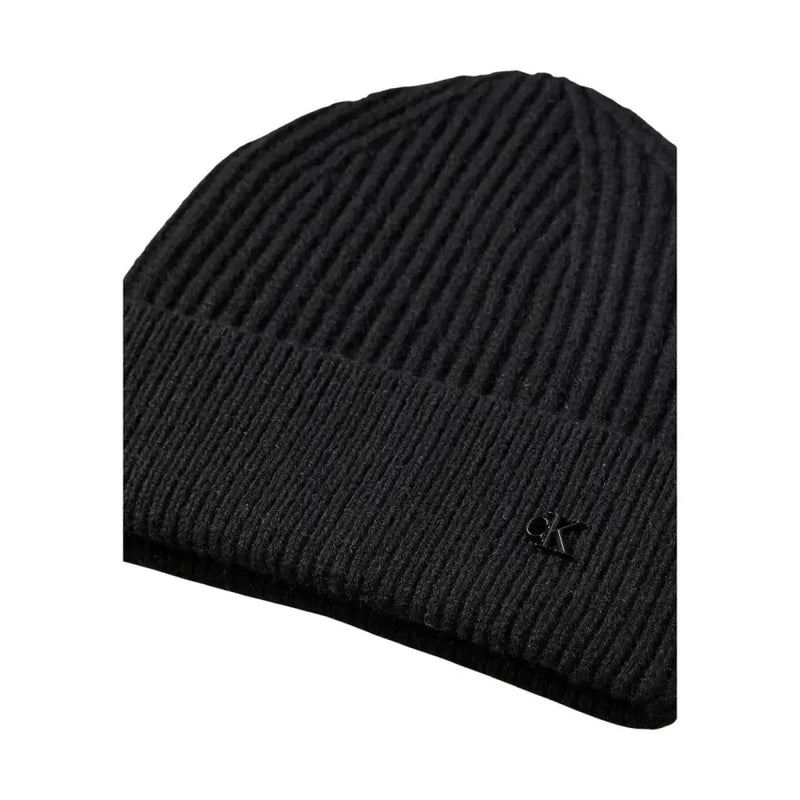 Black ribbed knit beanie with logo detail on the brim.