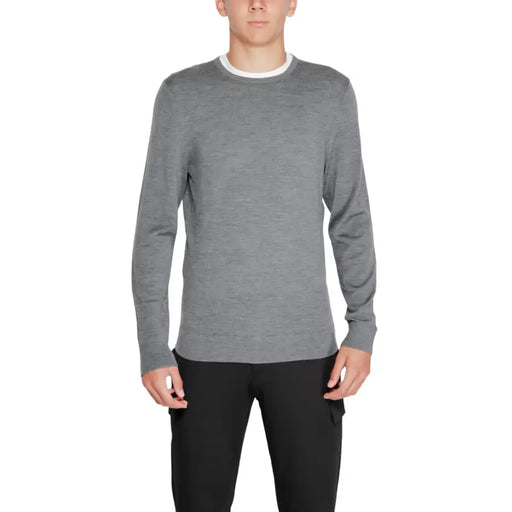 Charcoal gray crew neck sweater with white trim and textured knit design.