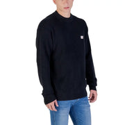 Black crewneck sweater with small white logo on chest, likely made of cotton or polyester blend.