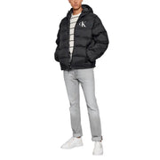 Black calvin klein puffer jacket with hood and white logo.