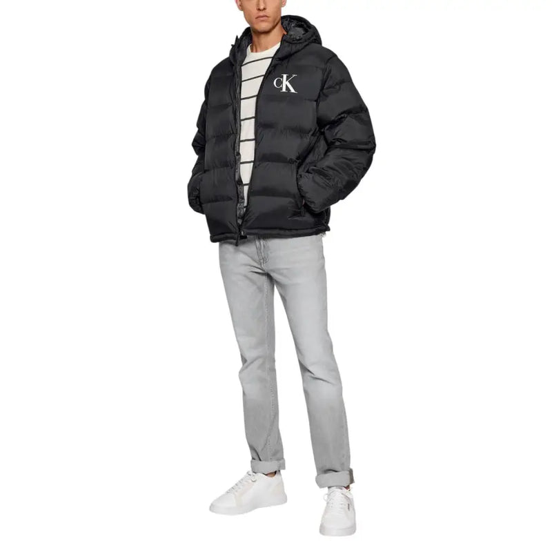 Black calvin klein puffer jacket with hood and white logo.