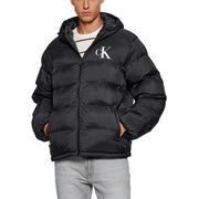 Black calvin klein puffer jacket with hood and logo on chest.